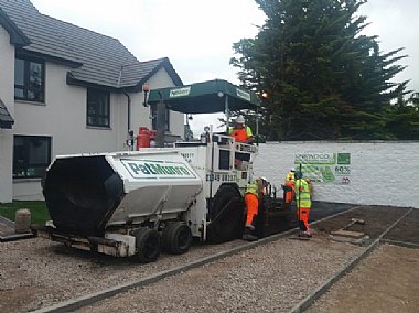 Surfacing squad laying new plastic waste road